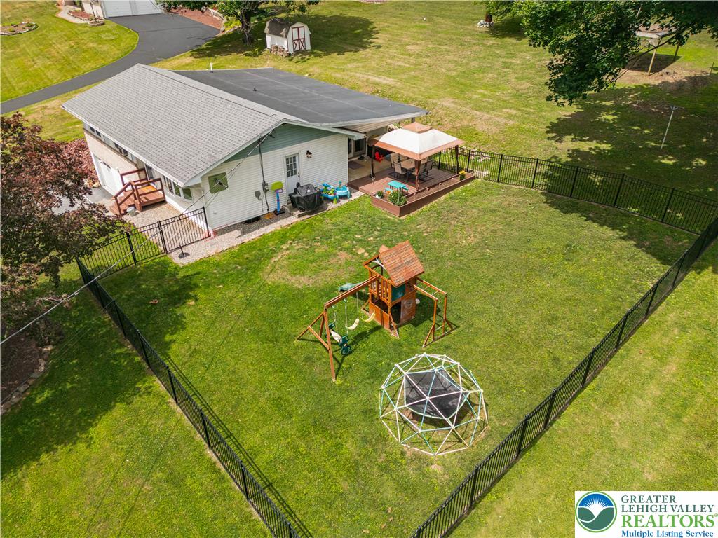 50 Kohls Road Northampton, PA 18067 - Photo 48 of 54 A private fenced yard awaits with a playful swing set and an elevated deck for outdoor enjoyment.
