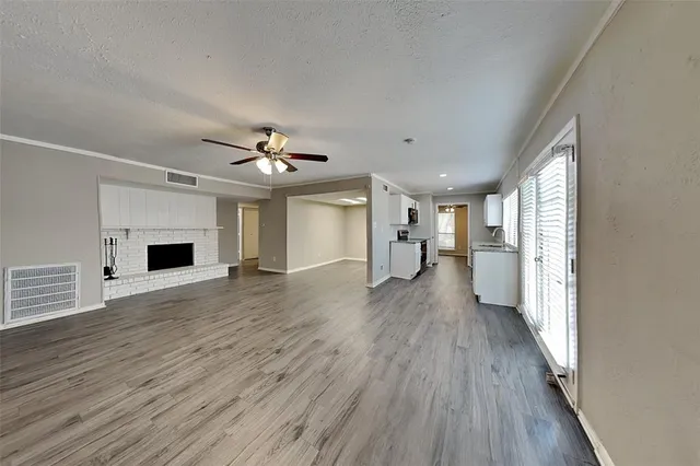 a view of a livingroom with wooden floor and a ceiling fan