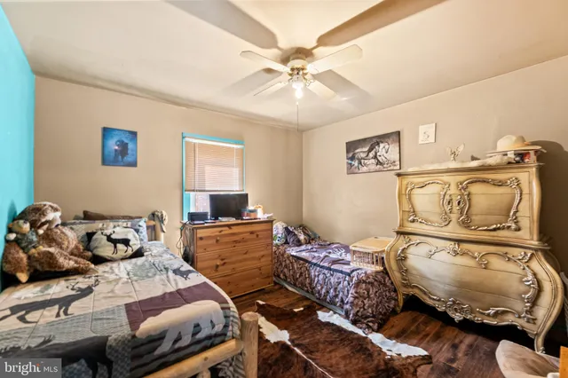 a bedroom with a bed and ceiling fan