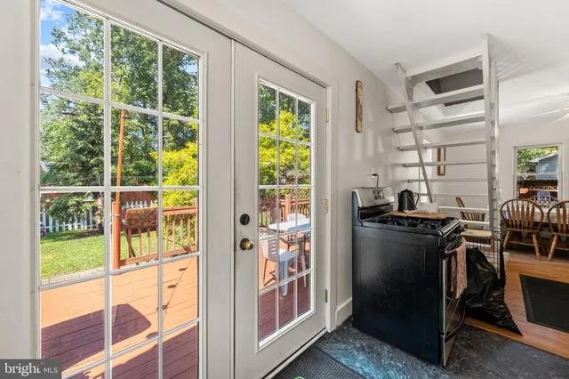 a view of a kitchen with furniture and large windows