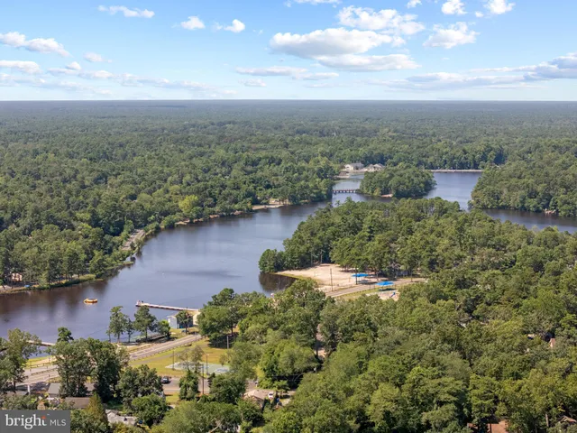 a view of a lake with middle of green space