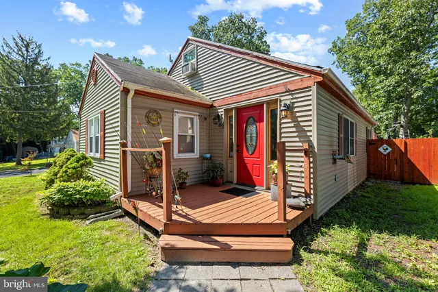 a view of backyard with deck and outdoor seating