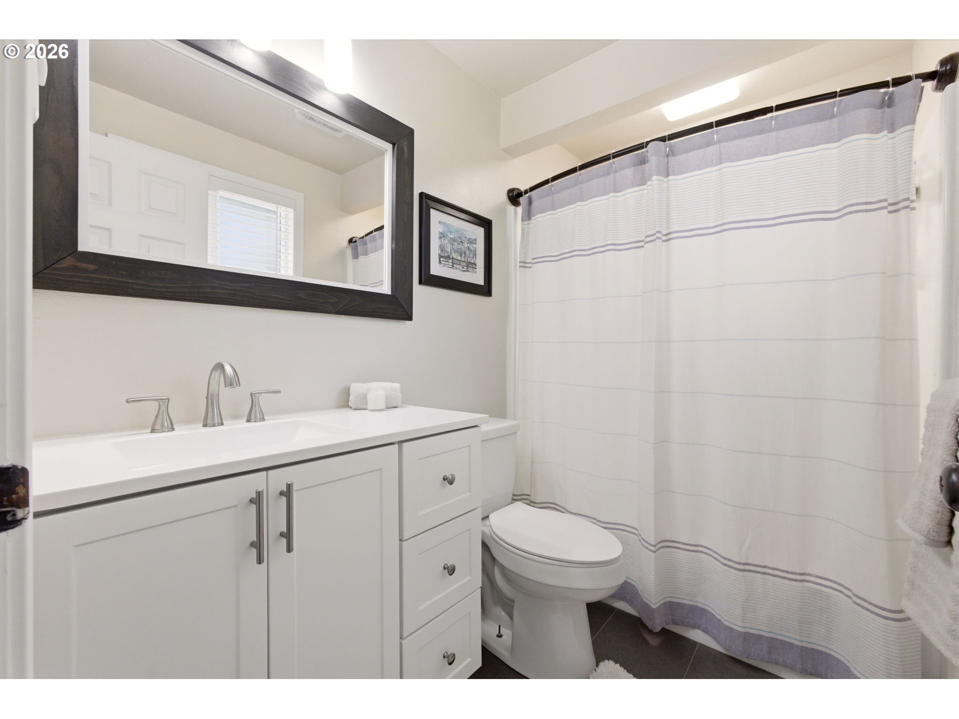 6 Dove Street Longview, WA 98632 - Photo 12 of 14 a bathroom with a toilet sink a mirror and vanity