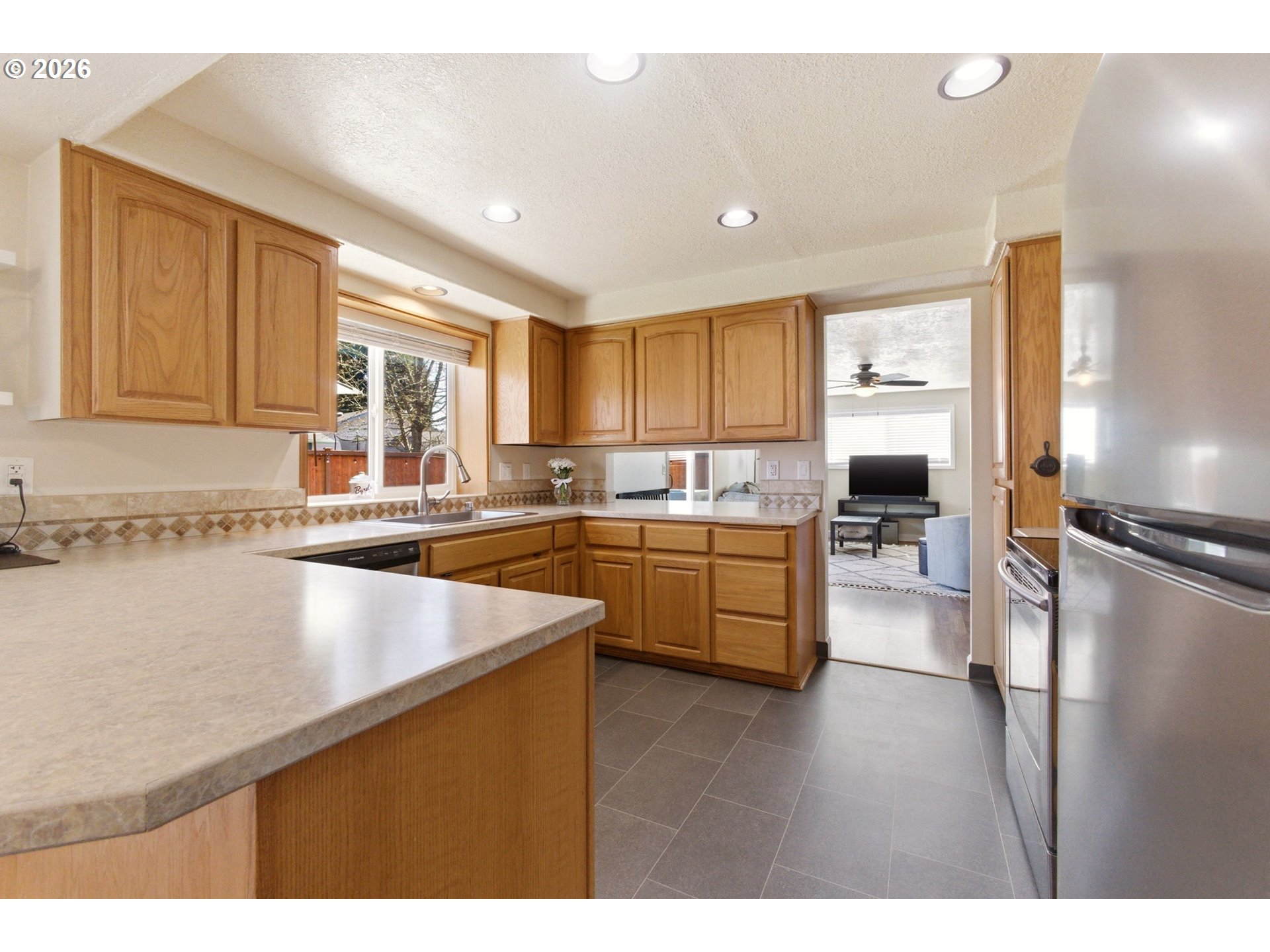 6 Dove Street Longview, WA 98632 - Photo 7 of 14 a kitchen with stainless steel appliances granite countertop a sink refrigerator and cabinets