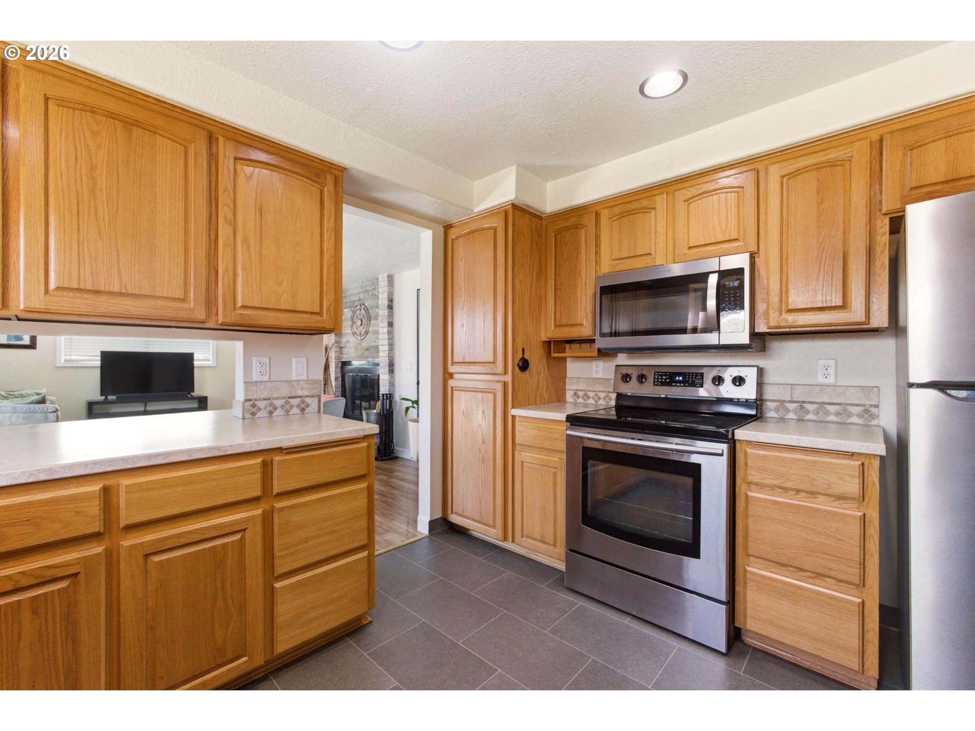 6 Dove Street Longview, WA 98632 - Photo 8 of 14 a kitchen with stainless steel appliances granite countertop a stove a sink and a microwave