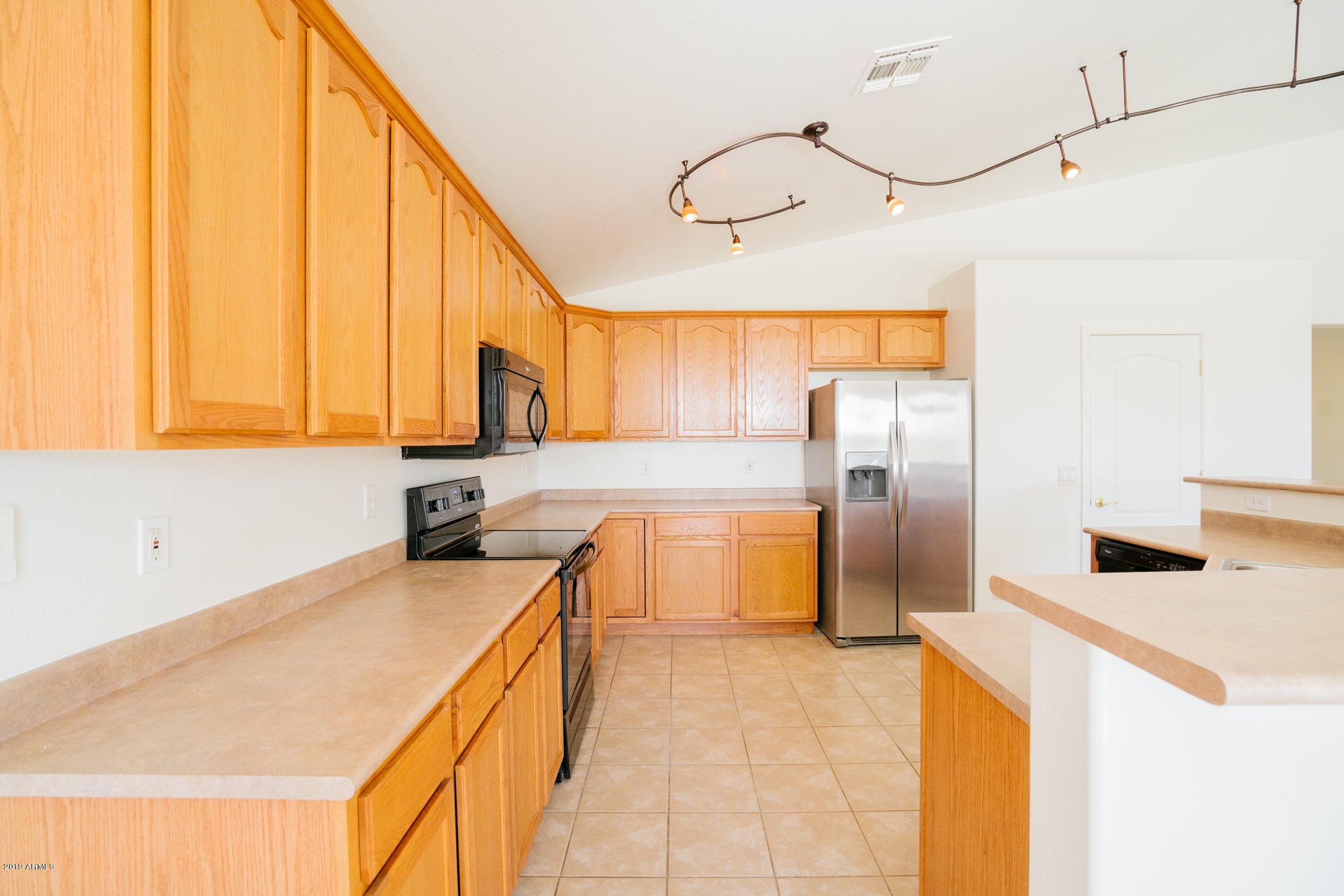 25555 West Ripple Road Buckeye, AZ 85326 - Photo 8 of 21 a kitchen with stainless steel appliances granite countertop a sink a stove and refrigerator
