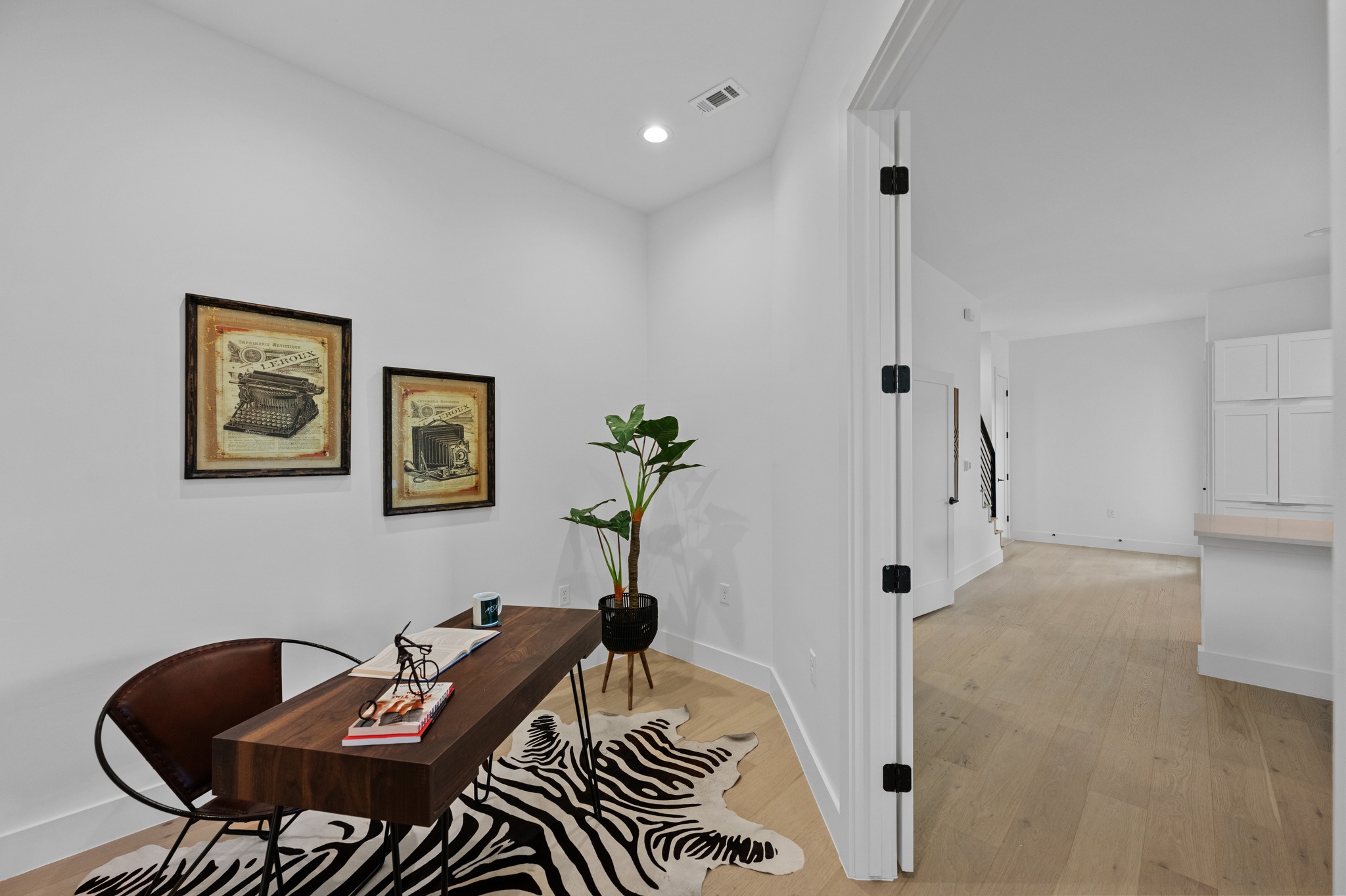 3614 Abbate Circle, Unit A Austin, TX 78721 - Photo 11 of 29 Room featuring light wood flooring, white walls, and a recessed ceiling light
