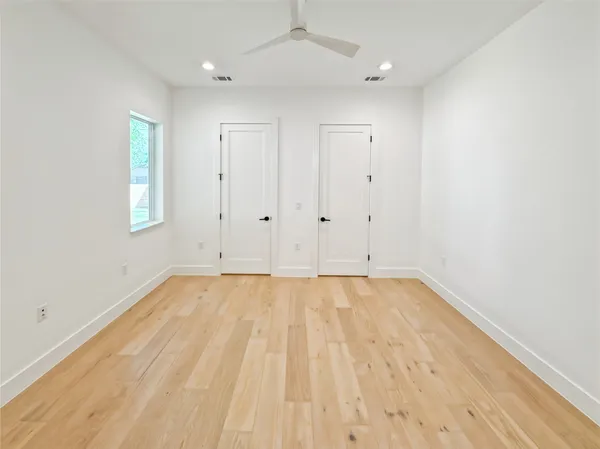 a bathroom with a double vanity sink mirror and a bathtub