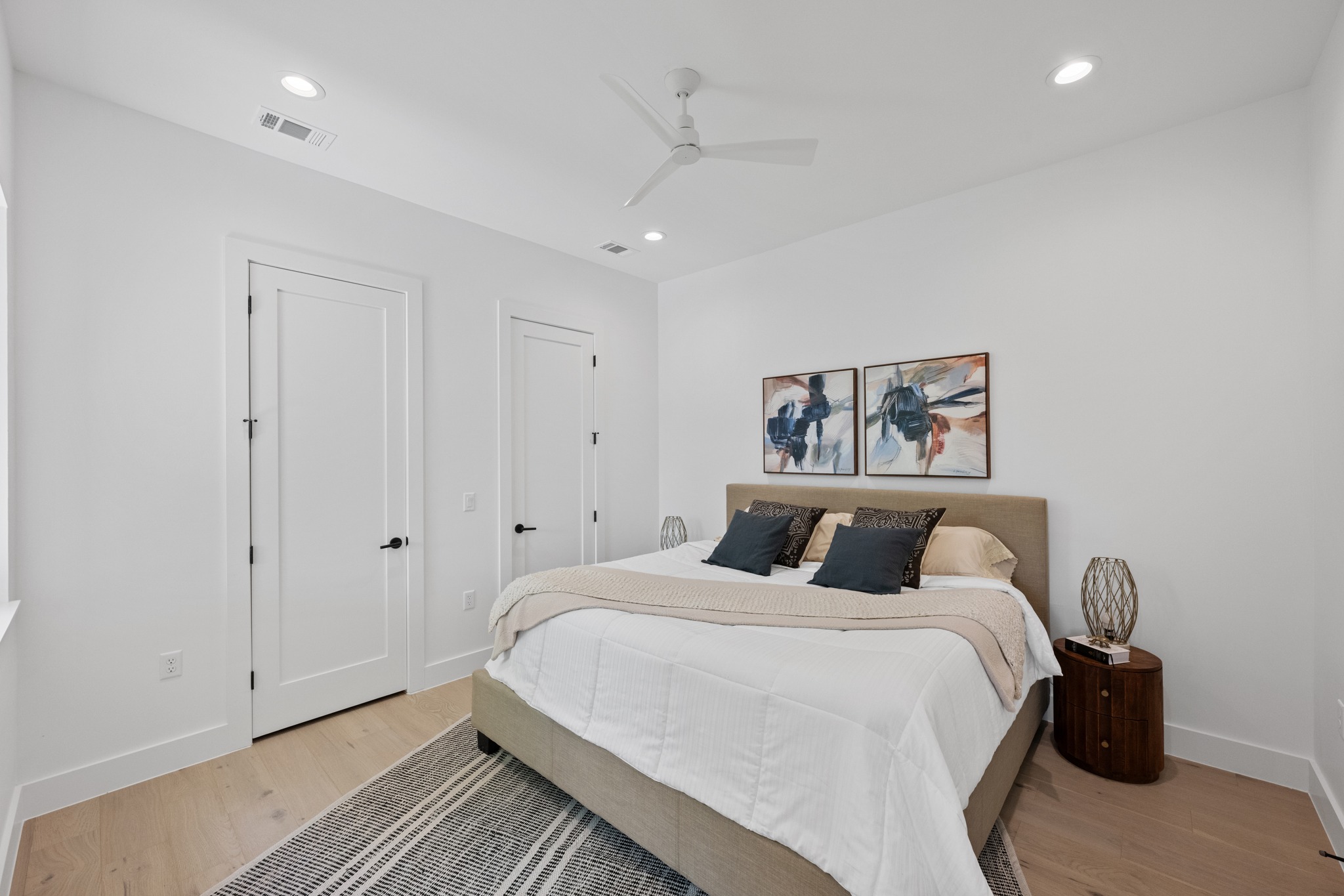 3614 Abbate Circle, Unit A Austin, TX 78721 - Photo 12 of 29 This room features light wood flooring, white walls, and recessed lighting