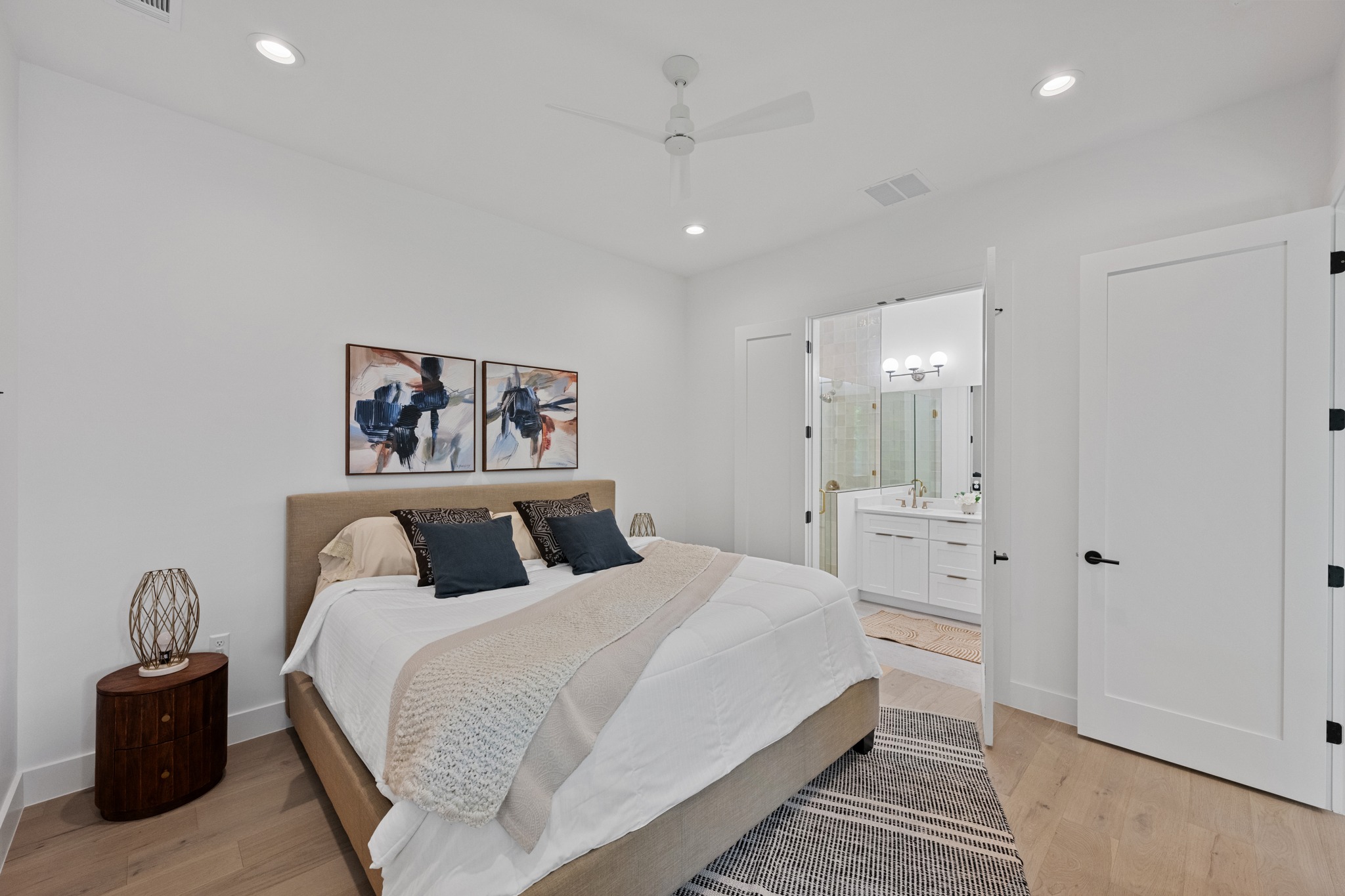 3614 Abbate Circle, Unit A Austin, TX 78721 - Photo 13 of 29 This bedroom features light wood flooring, recessed lighting, and a ceiling fan