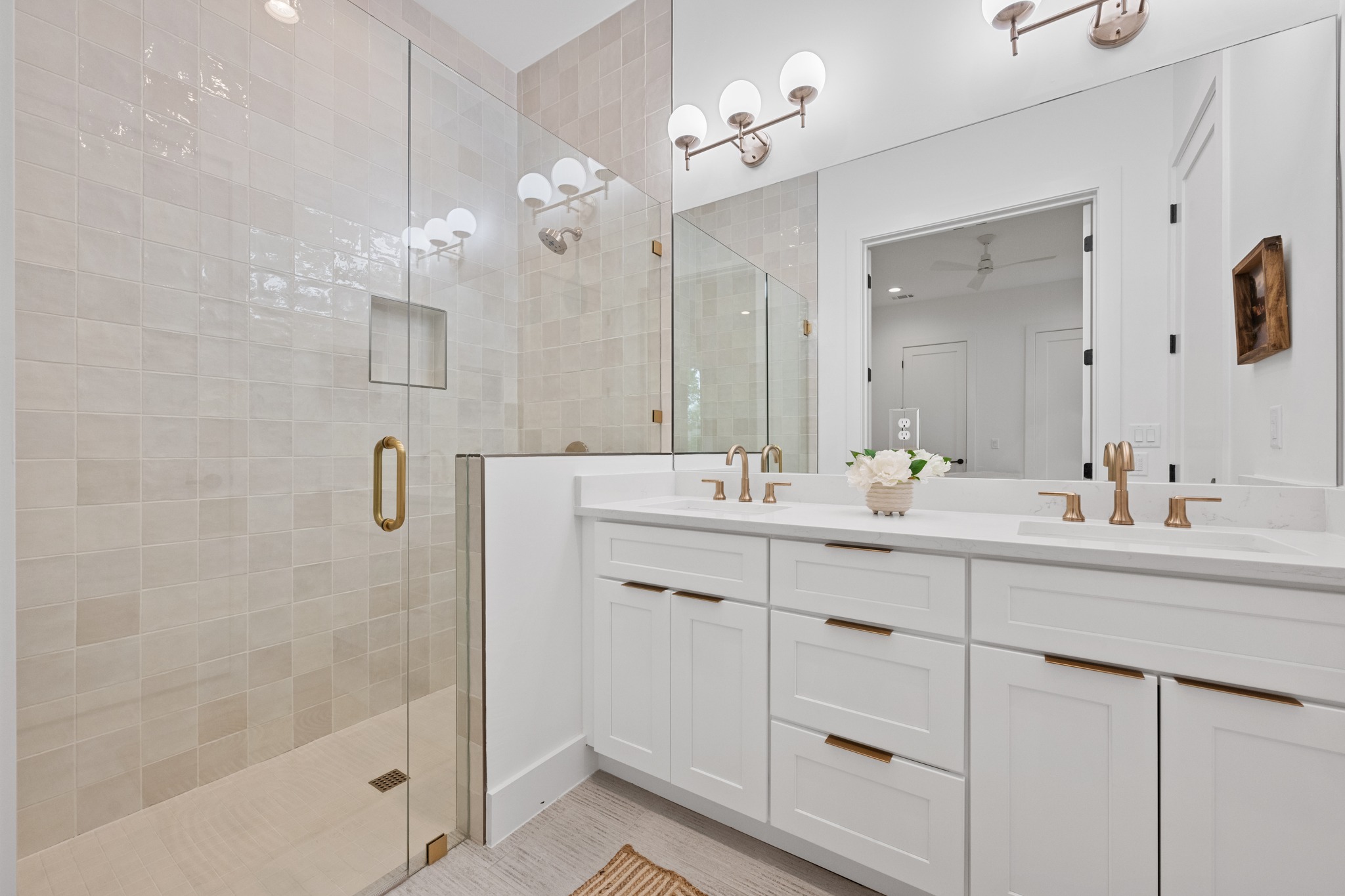 3614 Abbate Circle, Unit A Austin, TX 78721 - Photo 15 of 29 This bathroom features a spacious glass-enclosed shower with tiled walls and a built-in niche