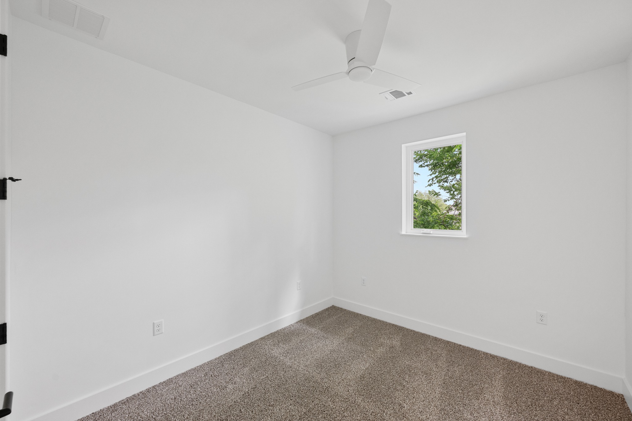 3614 Abbate Circle, Unit A Austin, TX 78721 - Photo 17 of 29 This room features light-colored walls, carpeted flooring, and a window providing natural light