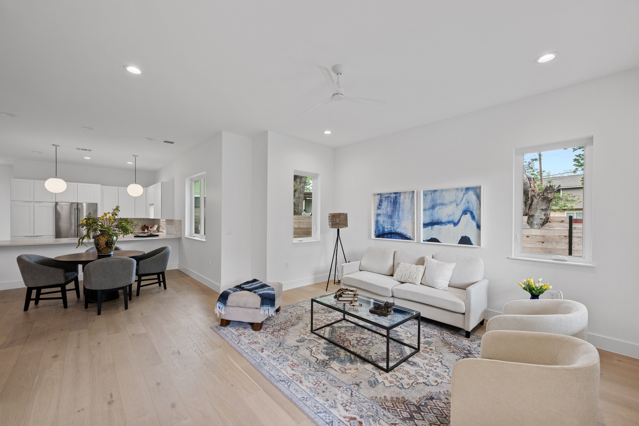 3614 Abbate Circle, Unit A Austin, TX 78721 - Photo 2 of 29 Spacious open-concept living area featuring light-toned hardwood flooring, recessed lighting, and large windows
