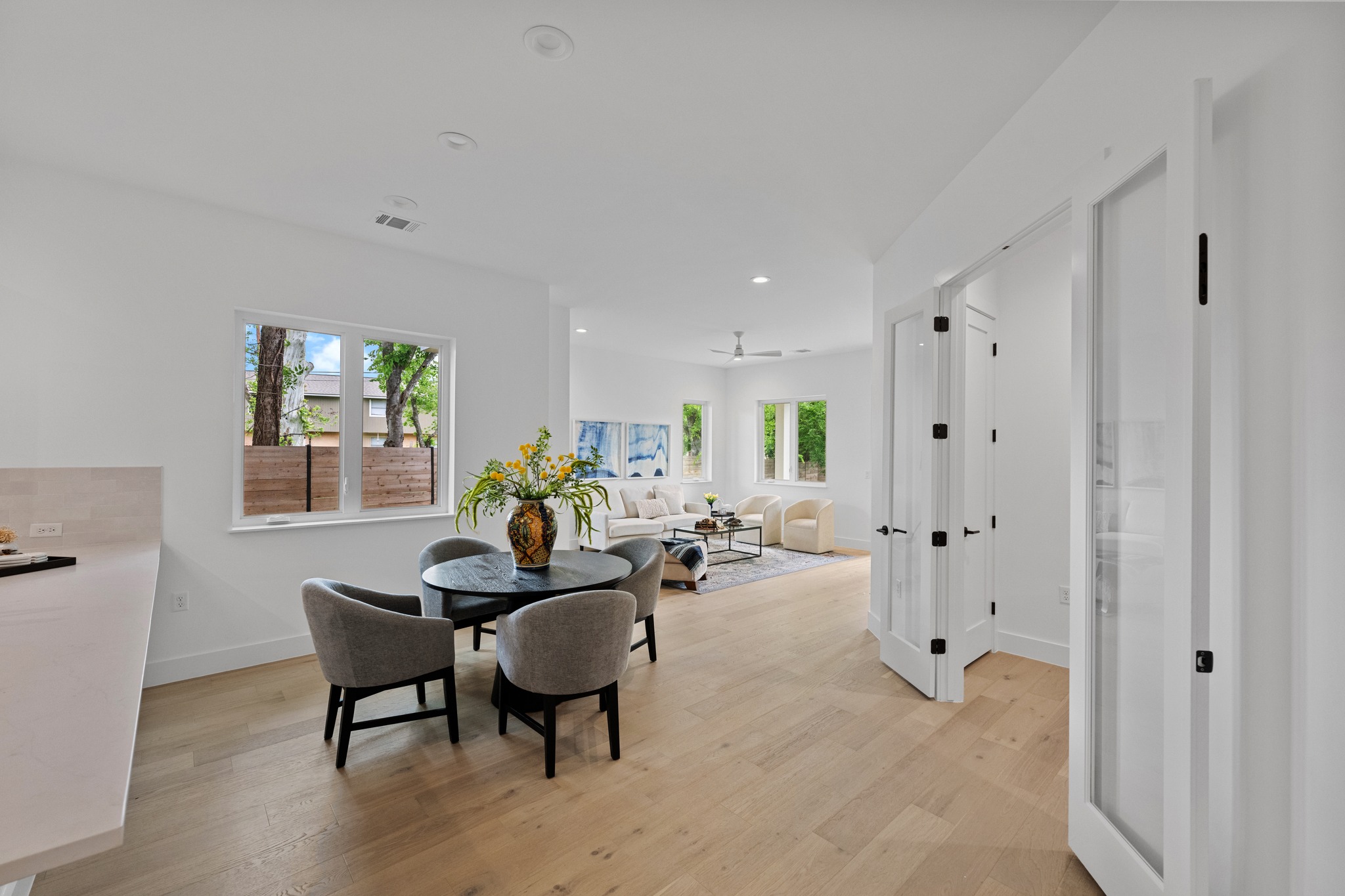 3614 Abbate Circle, Unit A Austin, TX 78721 - Photo 5 of 29 Open-concept living area with light hardwood floors, white walls, and recessed lighting