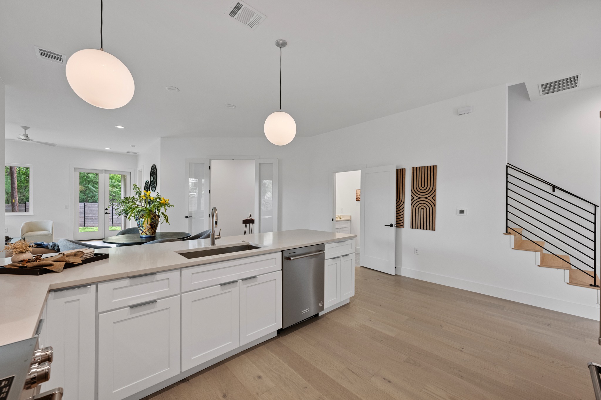 3614 Abbate Circle, Unit A Austin, TX 78721 - Photo 8 of 29 The kitchen features a spacious island with a sink and white cabinetry, complemented by stainless steel appliances