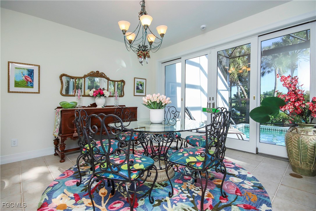 2548 Wulfert Road Sanibel, FL 33957 - Photo 11 of 36 a view of a dining room with furniture and a chandelier