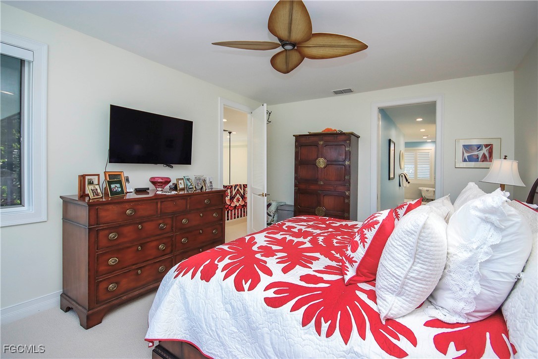 2548 Wulfert Road Sanibel, FL 33957 - Photo 18 of 36 a bedroom with a bed and a flat screen tv