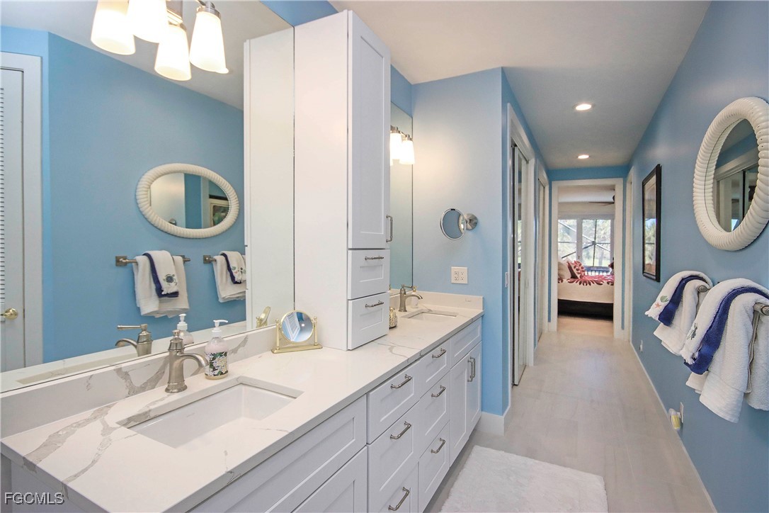 2548 Wulfert Road Sanibel, FL 33957 - Photo 21 of 36 a spacious bathroom with a granite countertop sink and a mirror