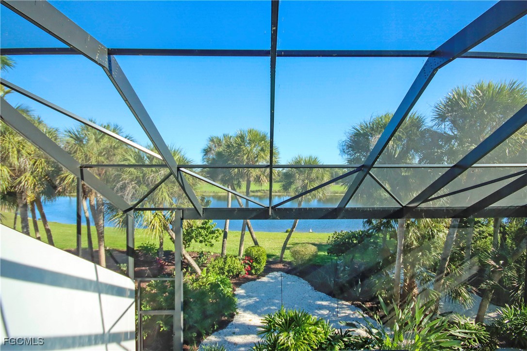 2548 Wulfert Road Sanibel, FL 33957 - Photo 22 of 36 a backyard of a house with table and chairs