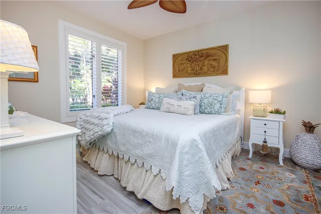 a bedroom with a bed window tv and couch