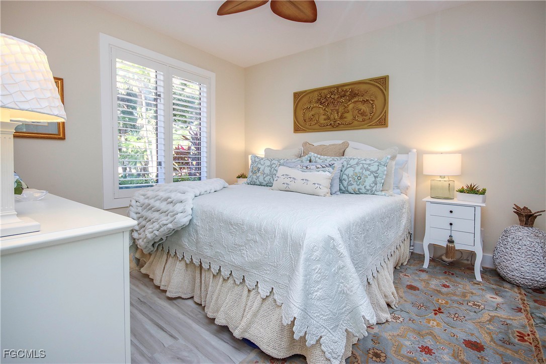2548 Wulfert Road Sanibel, FL 33957 - Photo 23 of 36 a bedroom with a bed and a table in it