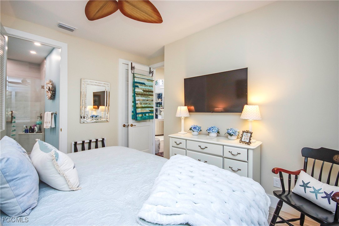 2548 Wulfert Road Sanibel, FL 33957 - Photo 25 of 36 a bedroom with a bed and a flat screen tv