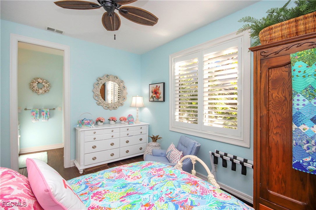 2548 Wulfert Road Sanibel, FL 33957 - Photo 28 of 36 a bedroom with a bed and window