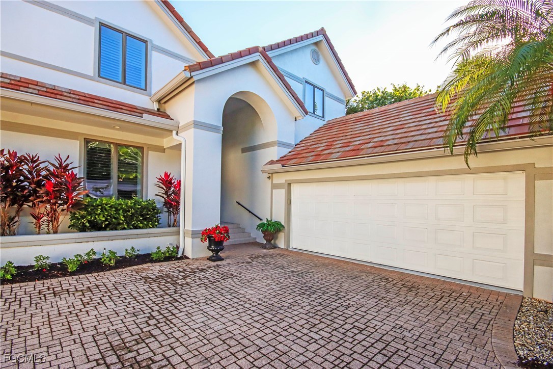 2548 Wulfert Road Sanibel, FL 33957 - Photo 4 of 36 a view of front door and potted plants