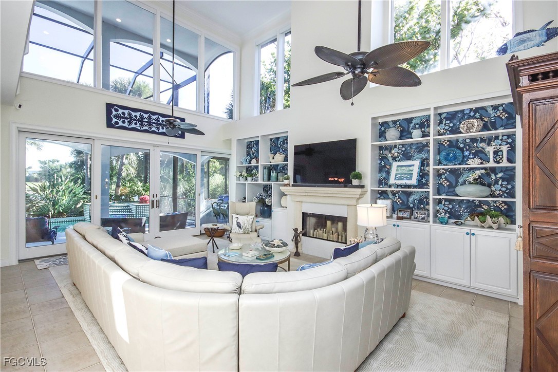 2548 Wulfert Road Sanibel, FL 33957 - Photo 6 of 36 a living room with fireplace furniture and a flat screen tv