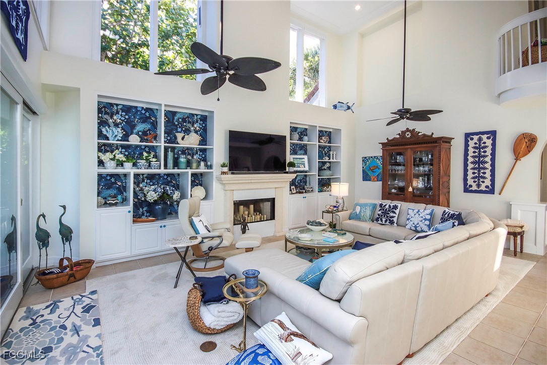 2548 Wulfert Road Sanibel, FL 33957 - Photo 7 of 36 a living room with fireplace furniture and a flat screen tv