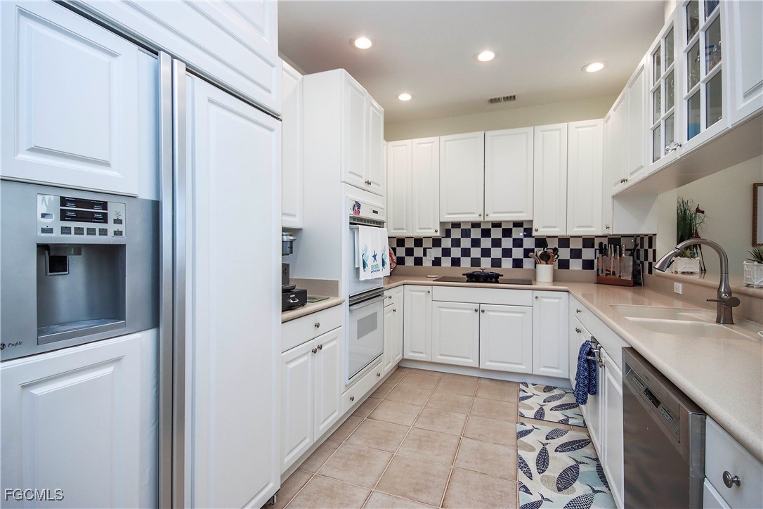2548 Wulfert Road Sanibel, FL 33957 - Photo 10 of 36 a kitchen with granite countertop a sink stove and cabinets