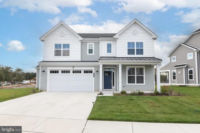 a front view of a house with a garden and yard