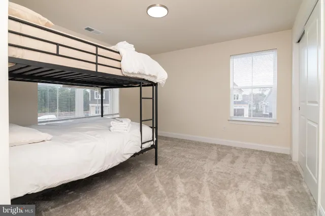 a bed sitting in a room next to a window