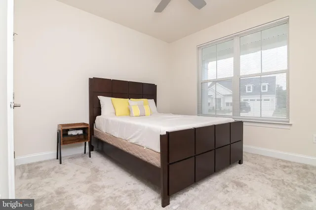 a spacious bedroom with a bed and a mirror