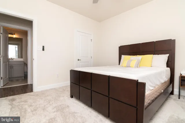 a bathroom with a toilet sink vanity and mirror