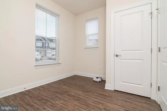 a view of a workspace with furniture and wooden floor