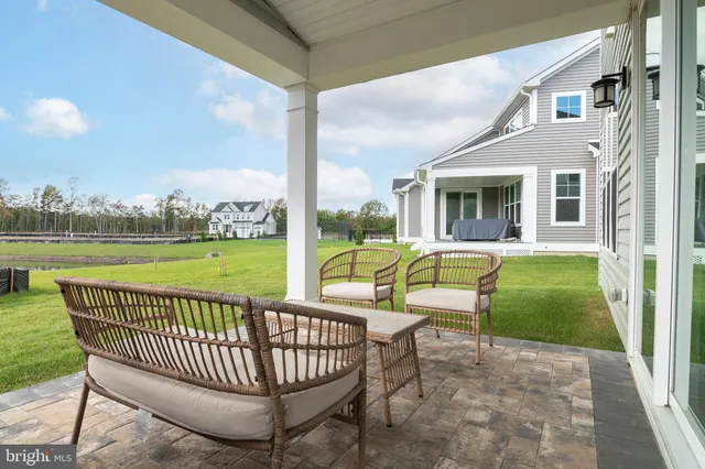 a building outdoor space with patio furniture and garden