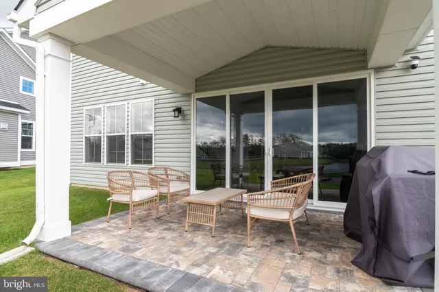 a view of a house with a yard and sitting area