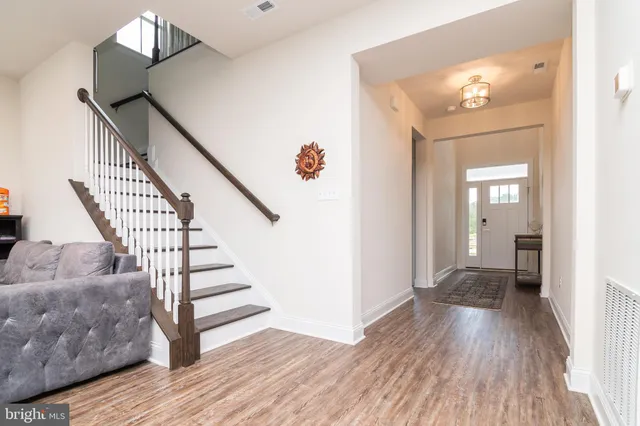 a view of a hallway view with wooden floor and staircase