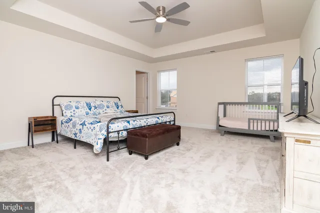 a spacious bedroom with a bed and a couch