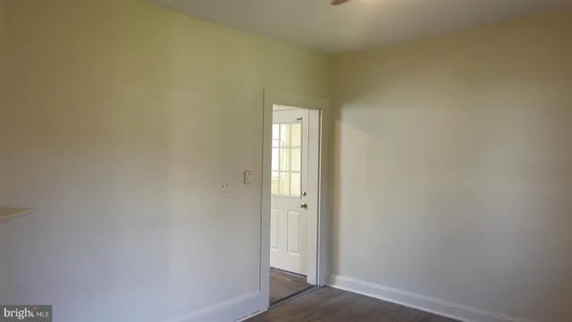 an empty room with a chandelier fan