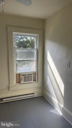a view of kitchen with granite countertop a stove and a wooden floors