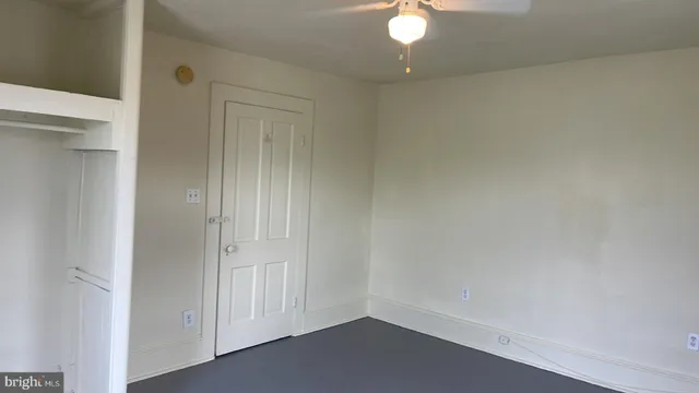 an empty room with wooden floor and a window
