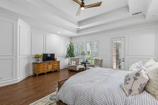 a spacious bedroom with a bed a couch and a large window