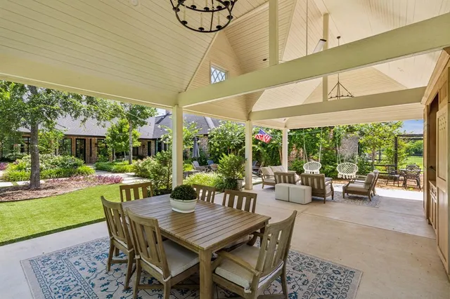 a view of a patio with a dining table and chairs