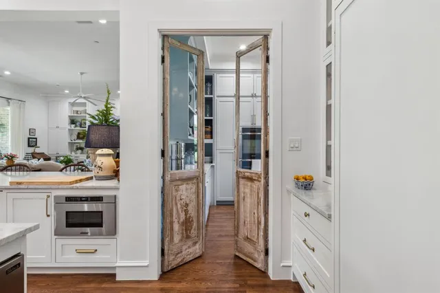 a kitchen with stainless steel appliances a sink a stove and cabinets