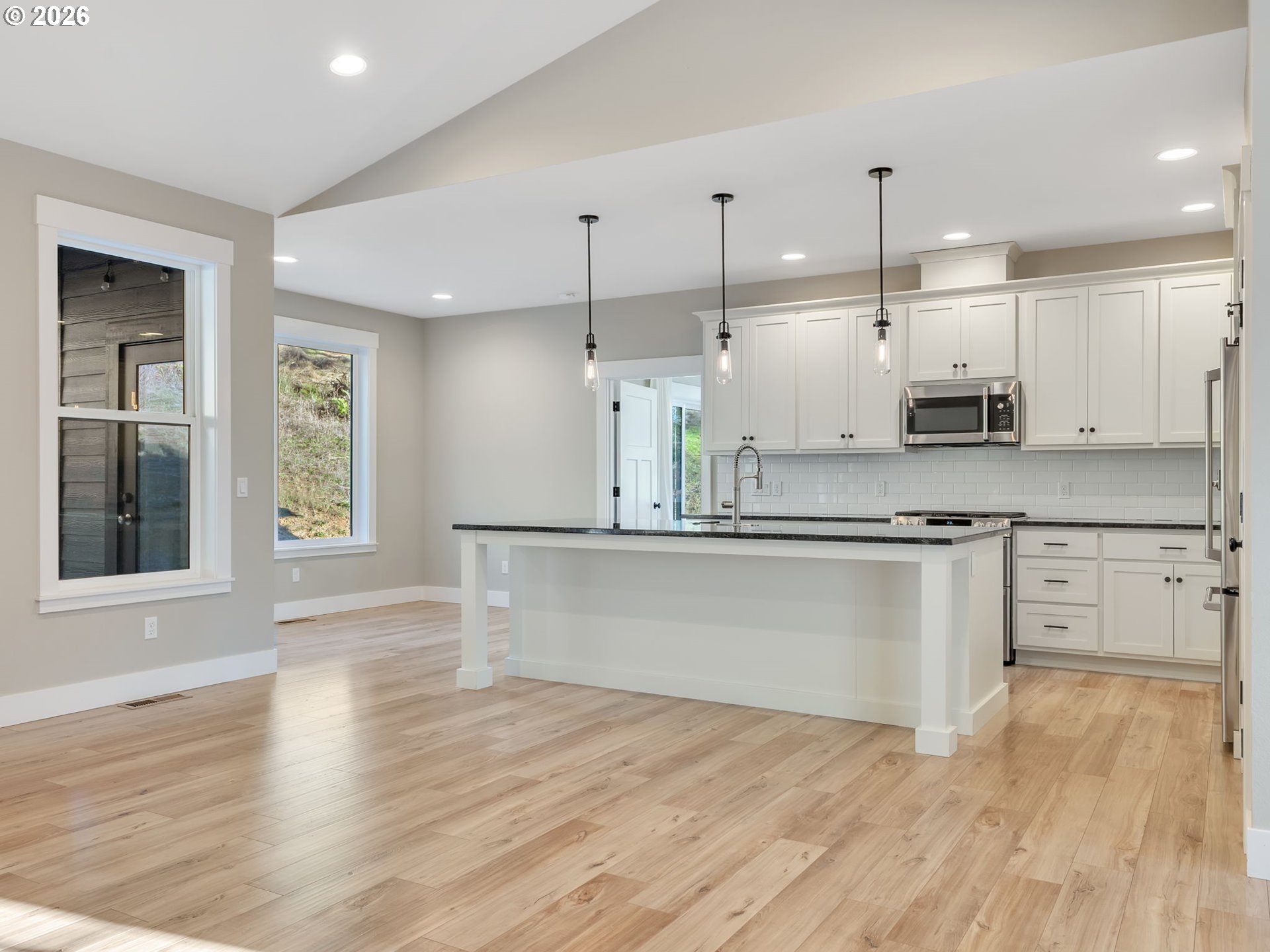 37027 Danner Ridge Lane Astoria, OR 97103 - Photo 15 of 46 a large kitchen with granite countertop a large counter top stainless steel appliances and wooden floor
