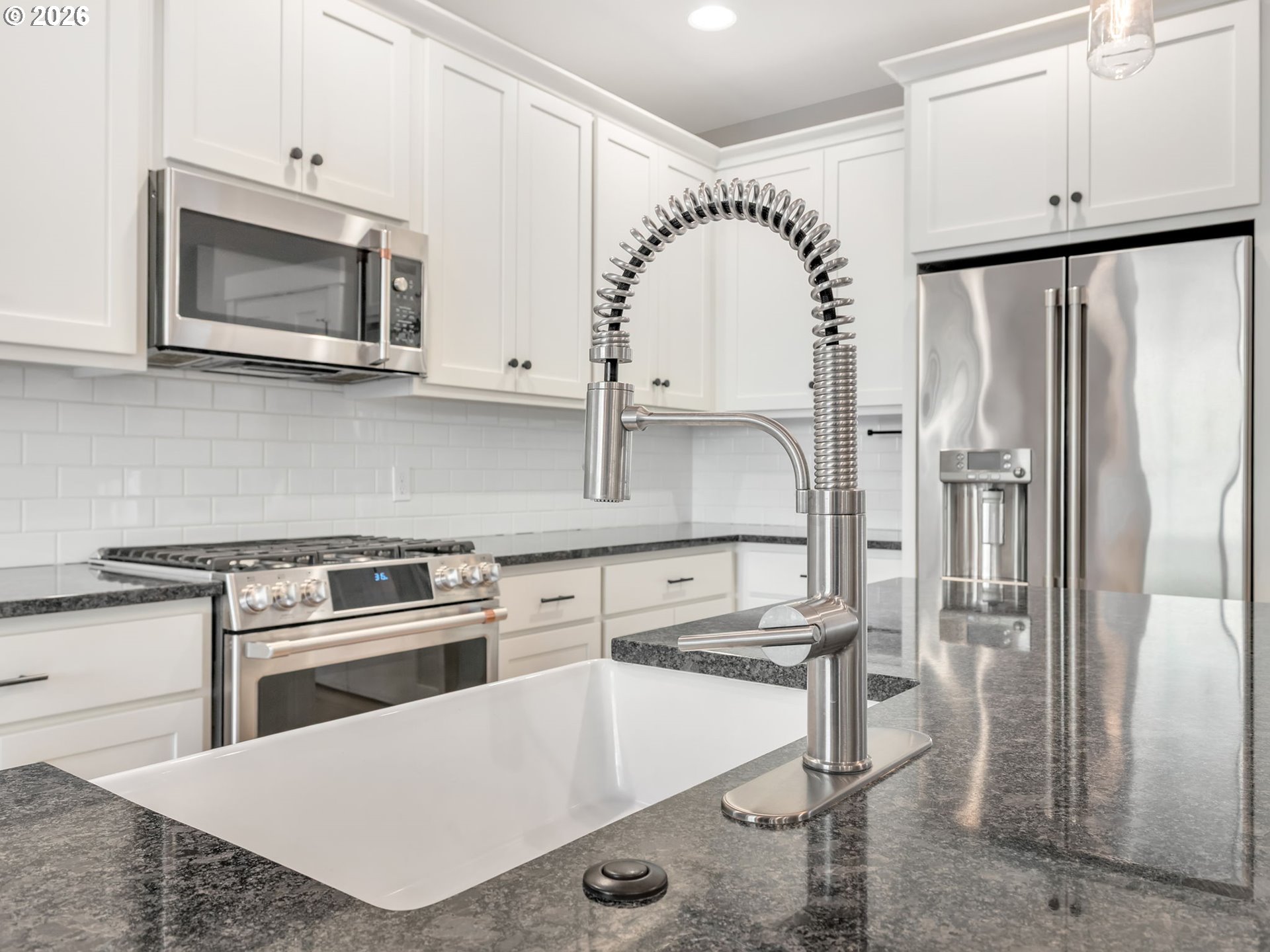 37027 Danner Ridge Lane Astoria, OR 97103 - Photo 19 of 46 a kitchen with stainless steel appliances granite countertop a stove a refrigerator and a microwave