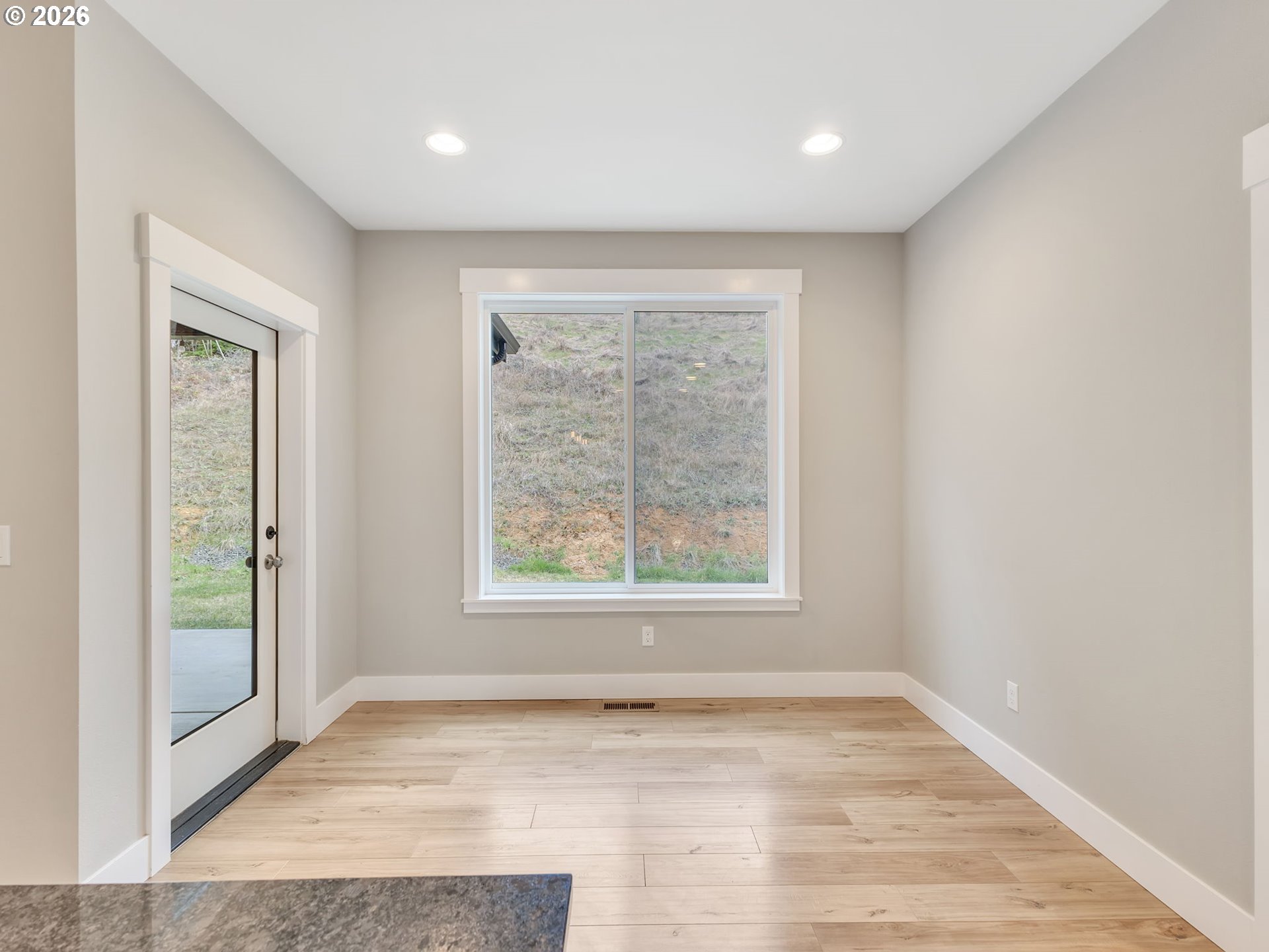37027 Danner Ridge Lane Astoria, OR 97103 - Photo 22 of 46 an empty room with wooden floor and windows