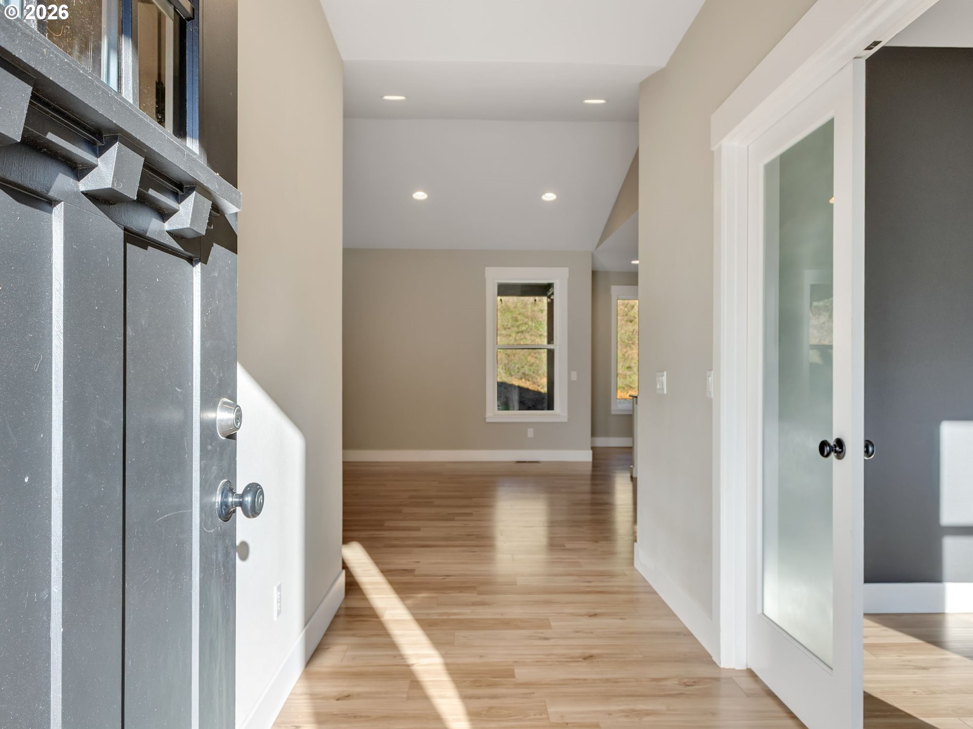 37027 Danner Ridge Lane Astoria, OR 97103 - Photo 4 of 46 a view of hallway with wooden floor and stairs